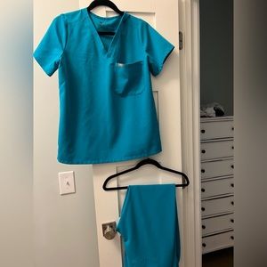 Teal scrub set with Jogger style pants . Small discoloration on pants see photo